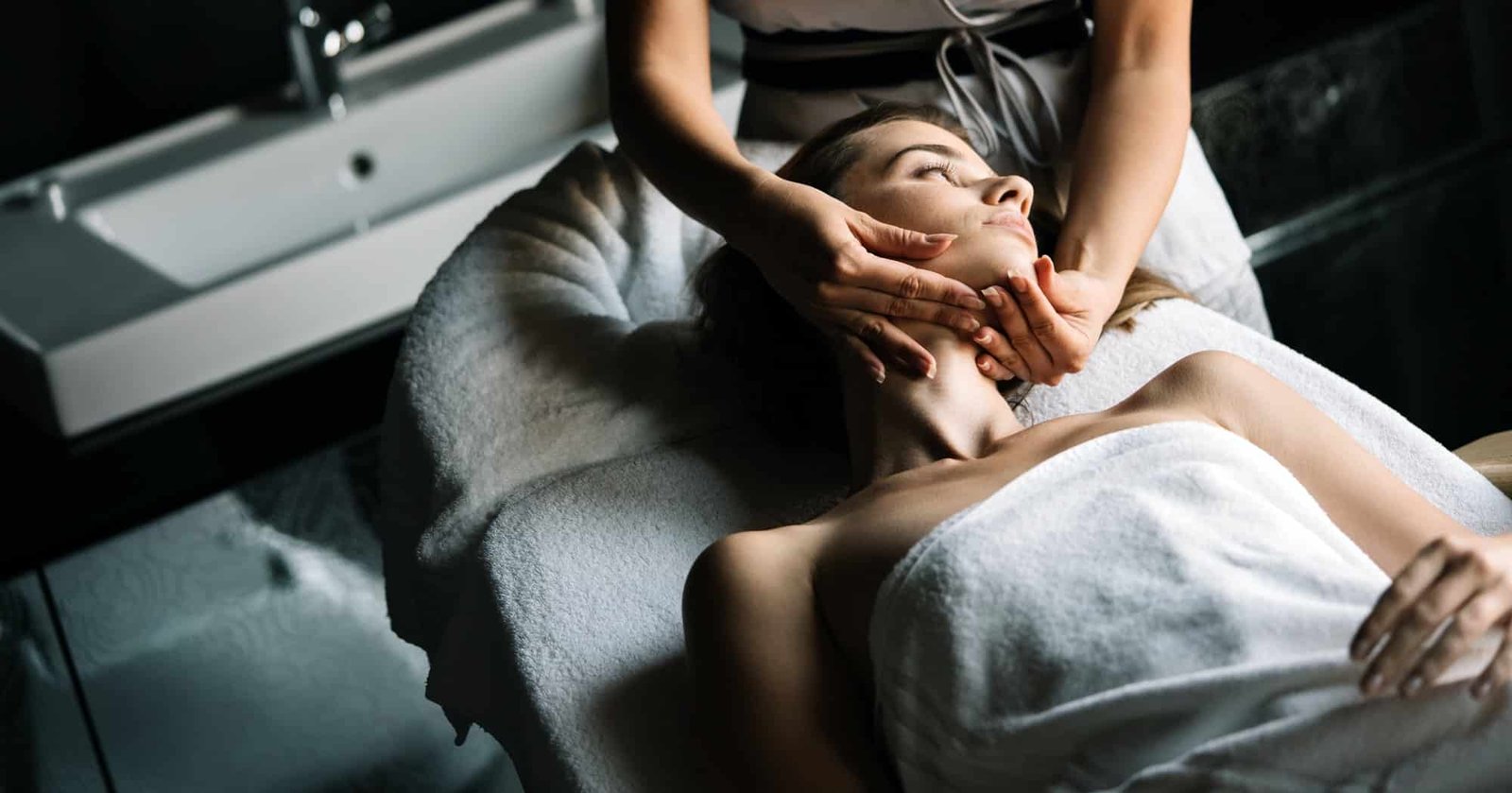 Young beautiful woman having massage in spa salon